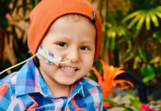 Cael smiling wearing an orange beanie