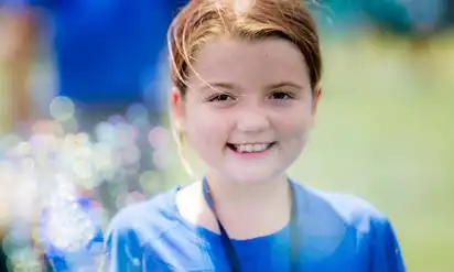 BCH patient Aileen smiles at the camera