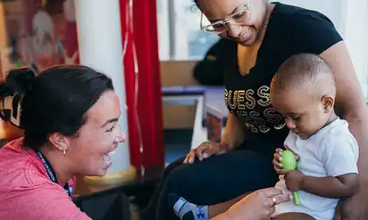 A nurse and parent attend to a small child