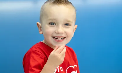 Jack smiling with his hand by his mouth