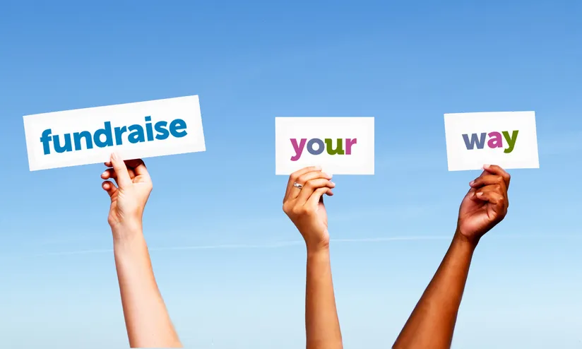three hands hold signs reading fundraise your way
