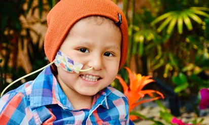 Cael smiling wearing an orange beanie
