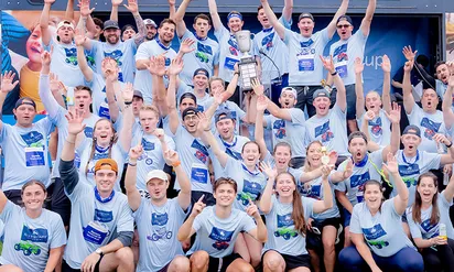 group of people raising their hands and cheering