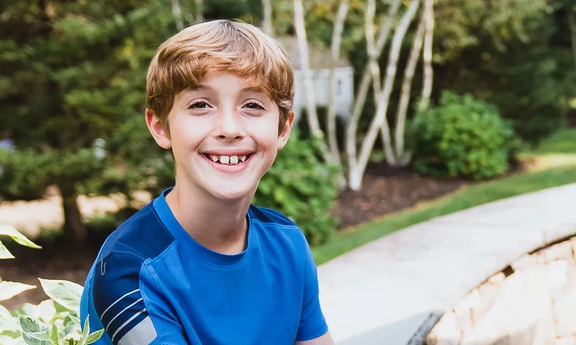 ryan sitting on a bench at a park