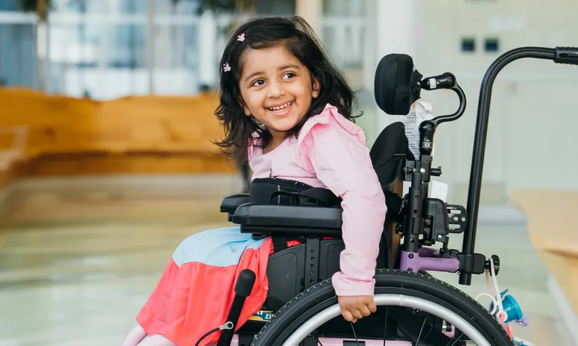 girl on wheelchair smiling