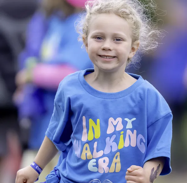 Group of kids wearing "in my walking era" blue t-shirts