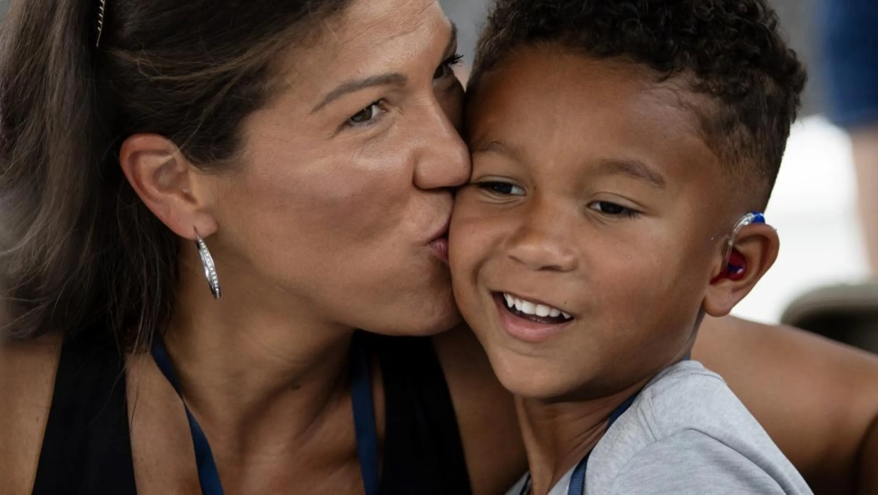 A mother kisses her son, Jeremiah