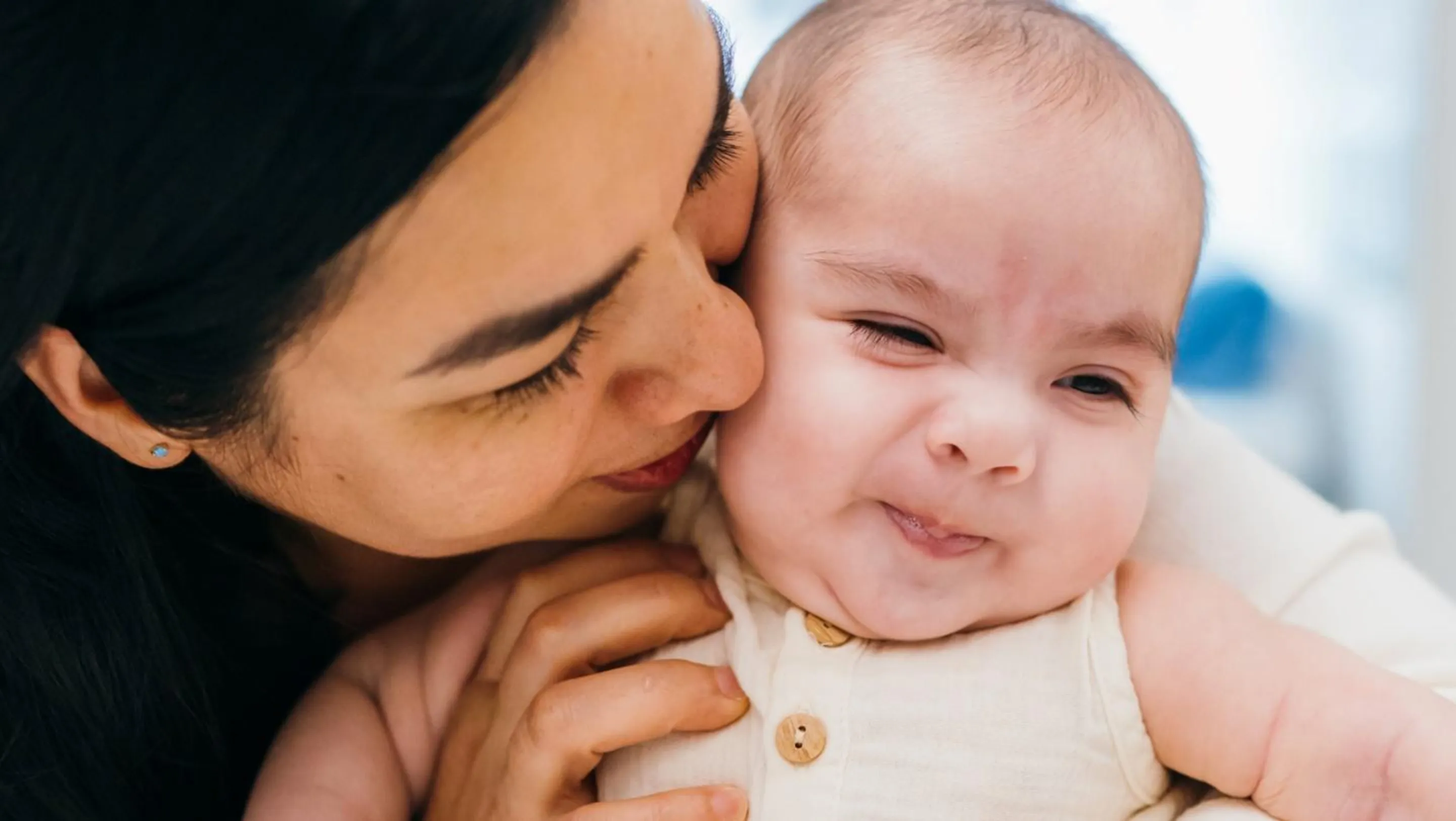 A mother kisses her baby son, Joshua