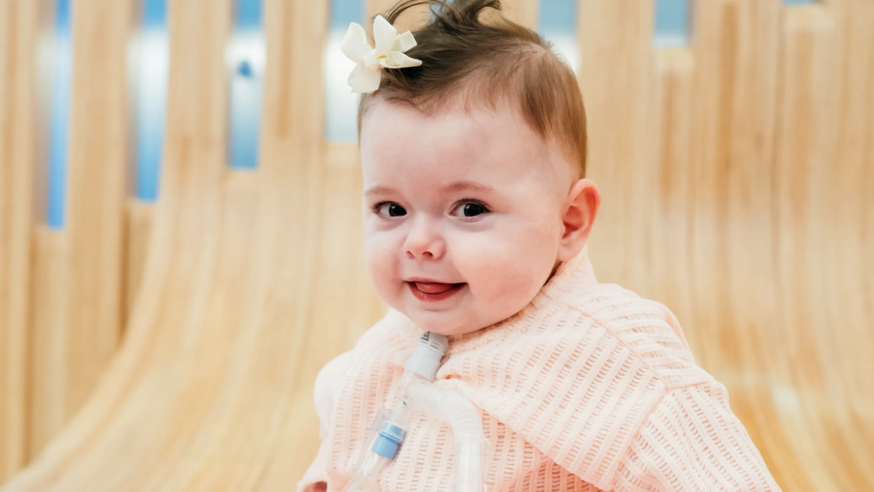 baby girl with bow tied in her hair