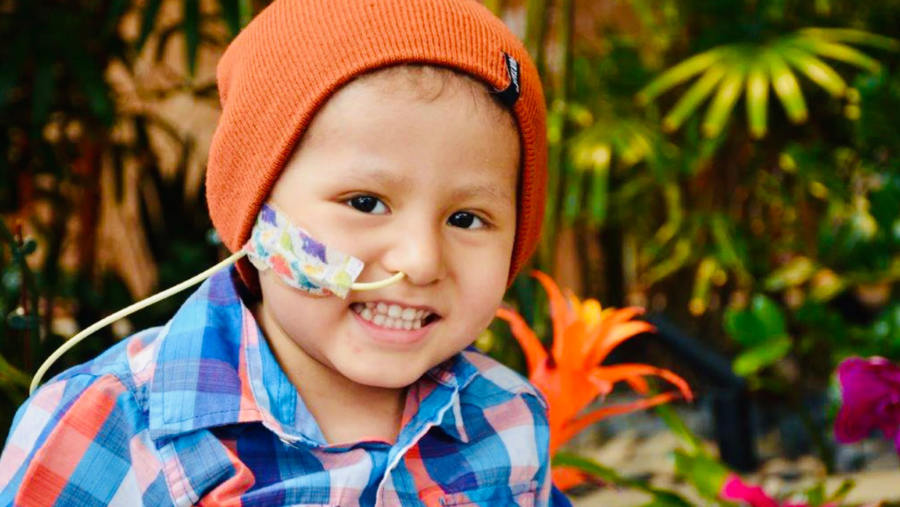 Cael smiling wearing an orange beanie