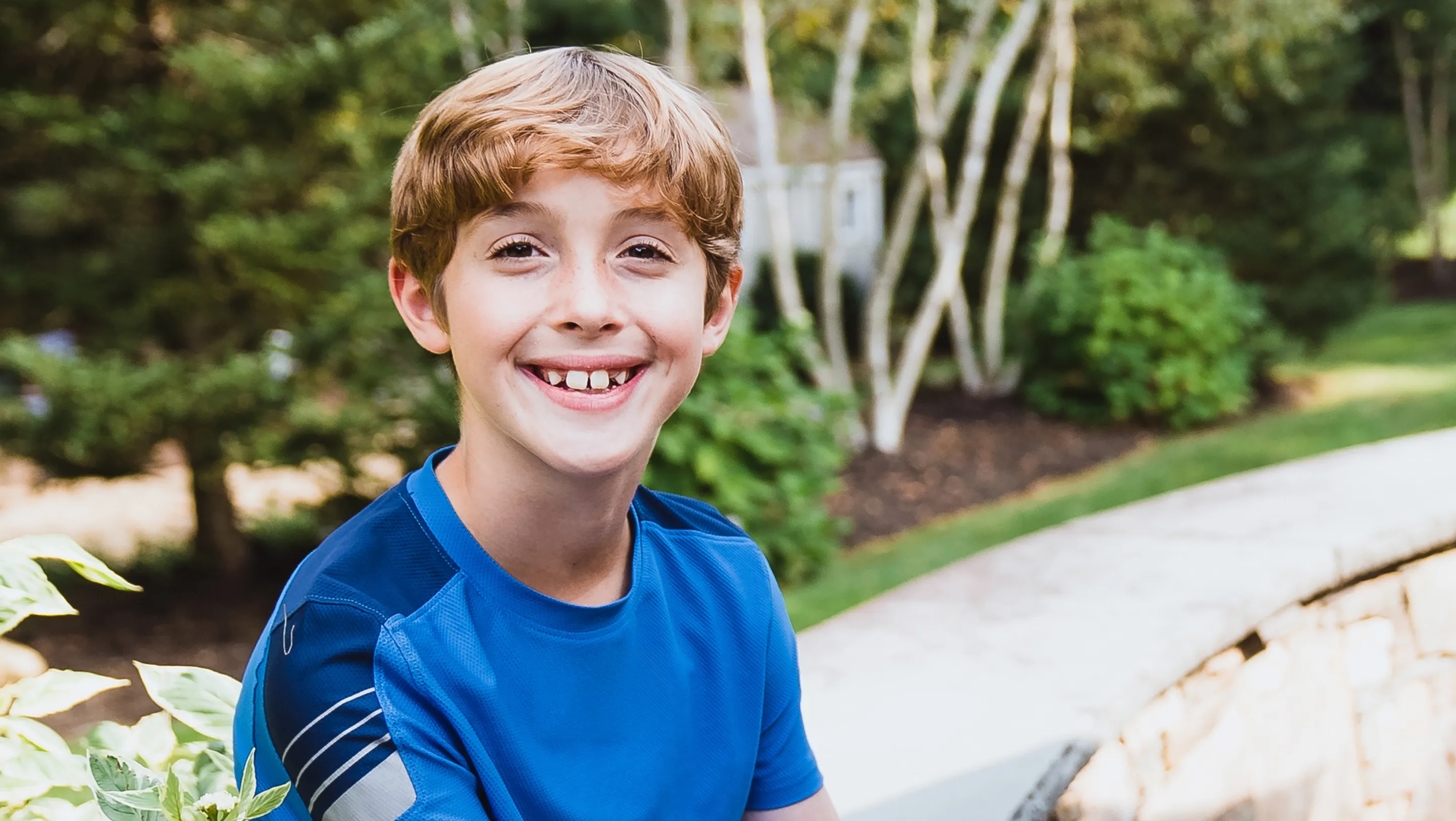 ryan sitting on a bench at a park