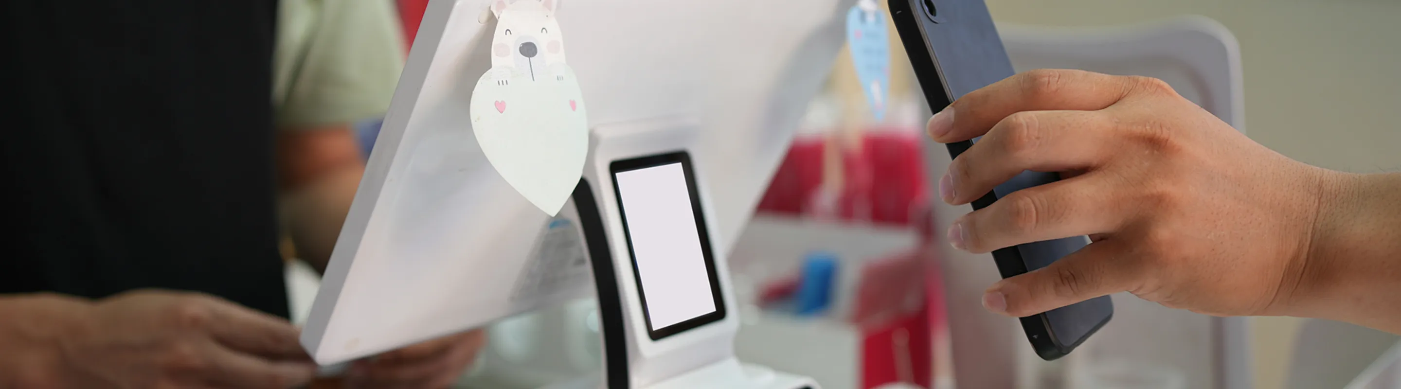 Someone uses their phone to pay at a cash register