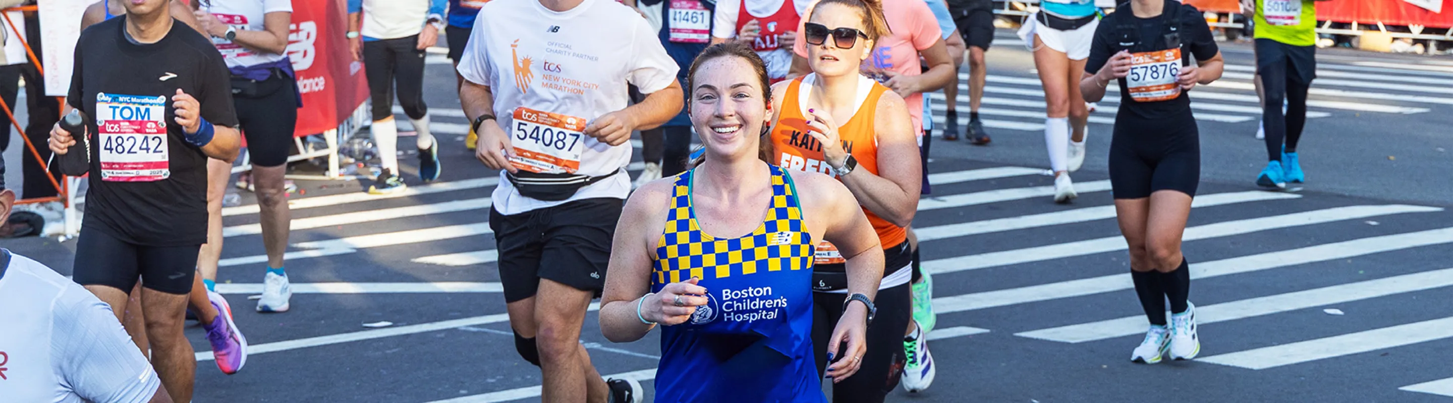 Woman running marathon smiling.