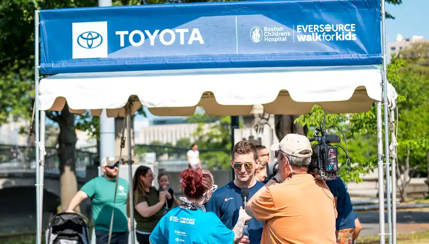 A Toyota sign on an outdoor pop-up tent