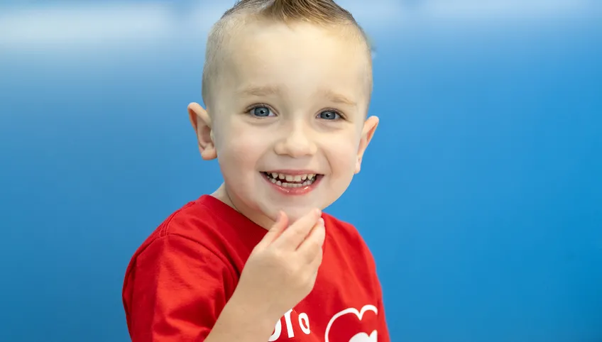 Jack smiling with his hand by his mouth