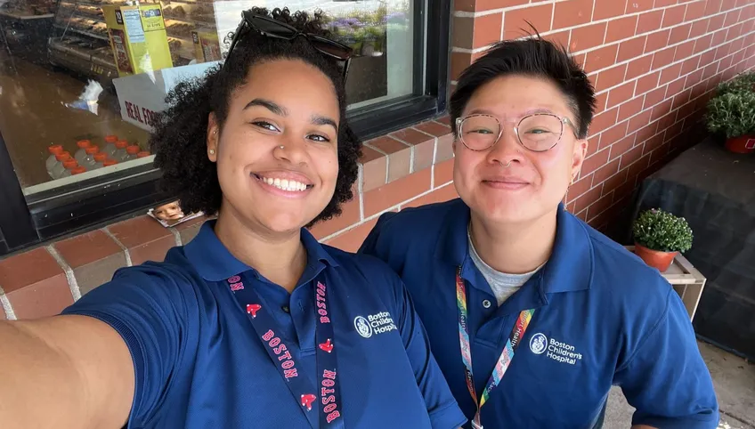 selfie of two Boston Children's Hospital canvassers with blue polo shirts