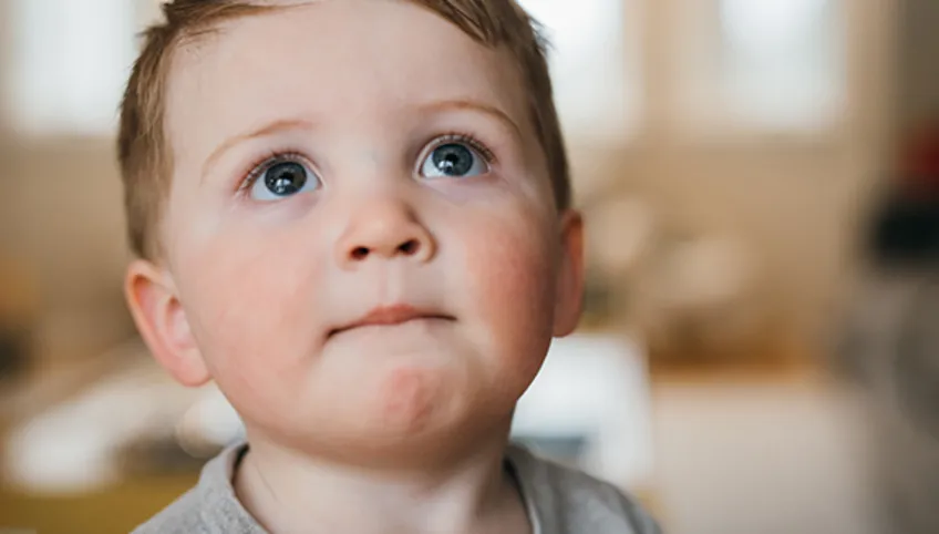 young boy looking upward and smiling