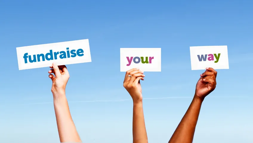 three hands hold signs reading fundraise your way