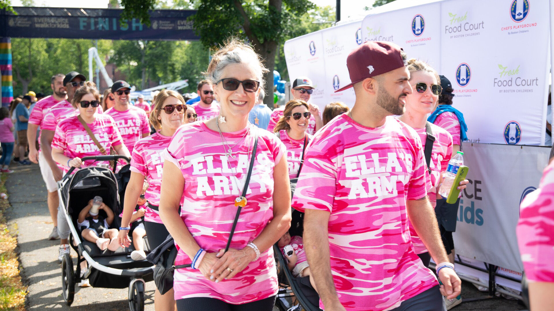 participants in pink tshirts walking for fundraising event