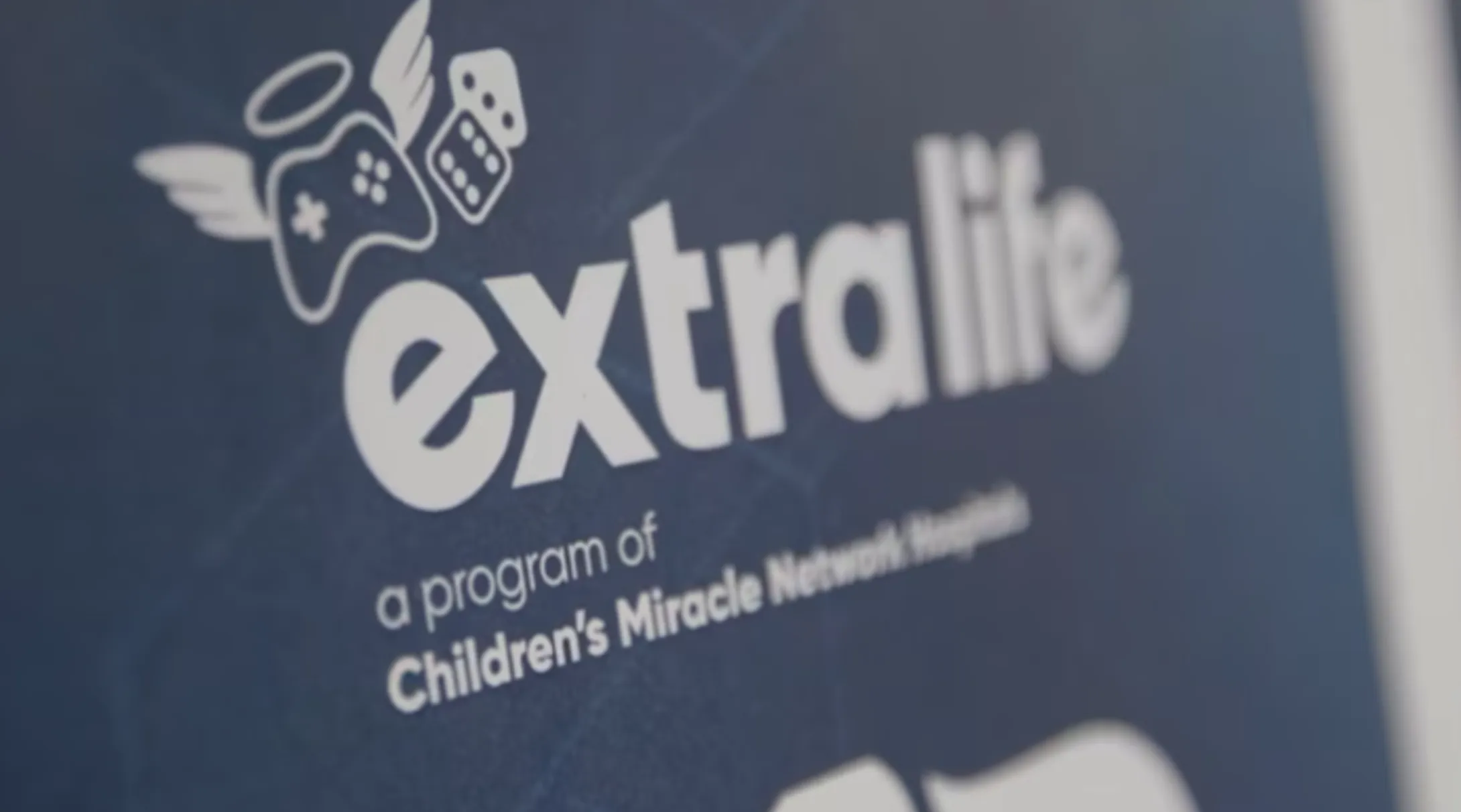A sign that reads "extra life, a program of Children's Miracle Network"