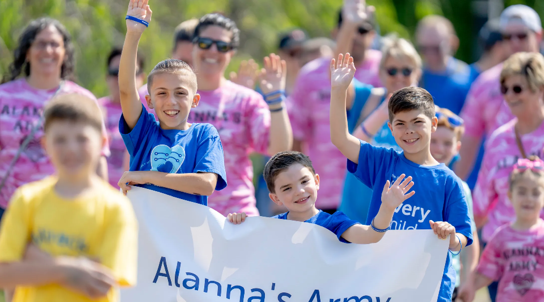 A group of Eversource Walk participants hold a banner that reads "Alanna's Army"
