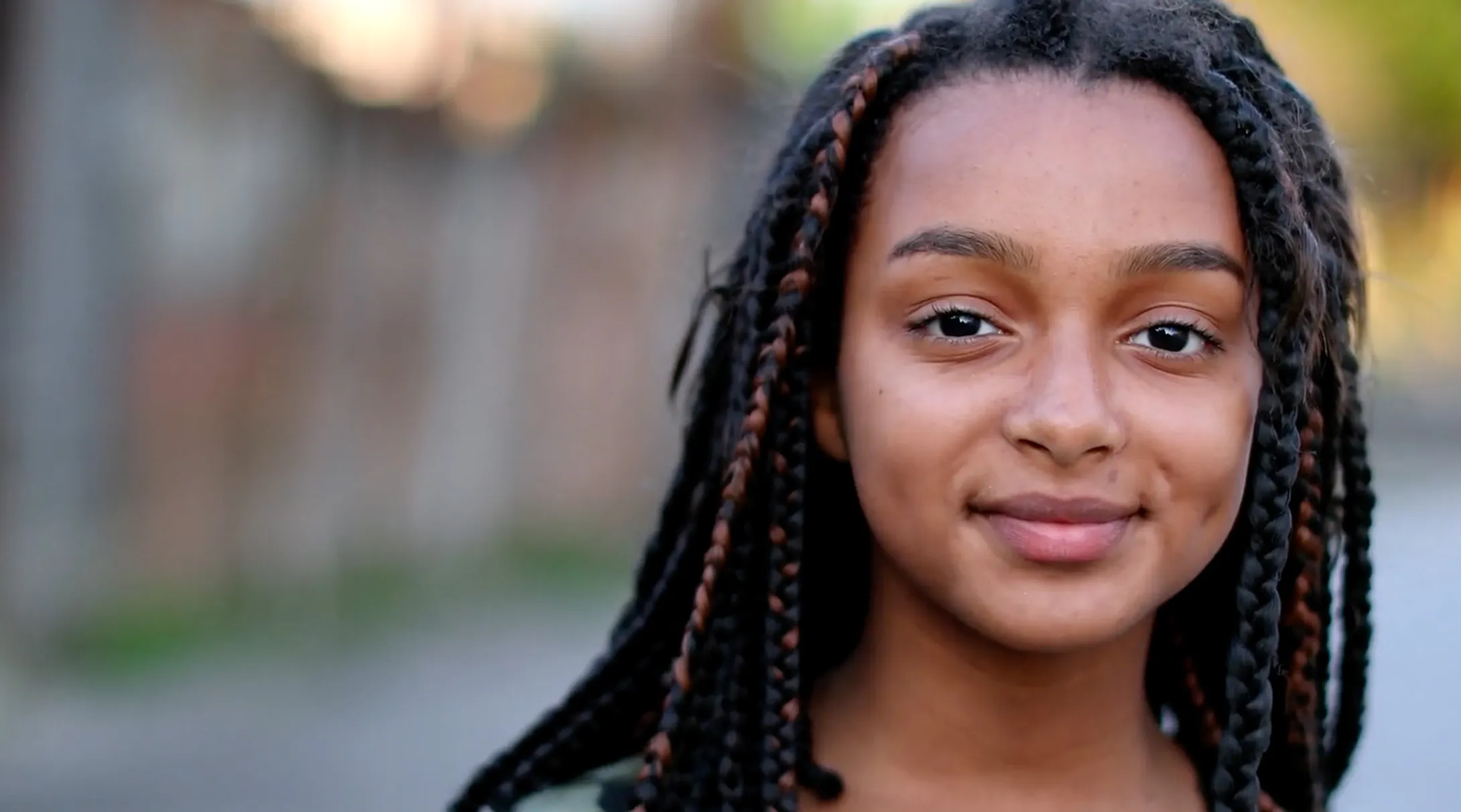 Girl with slight smile looking at the camera