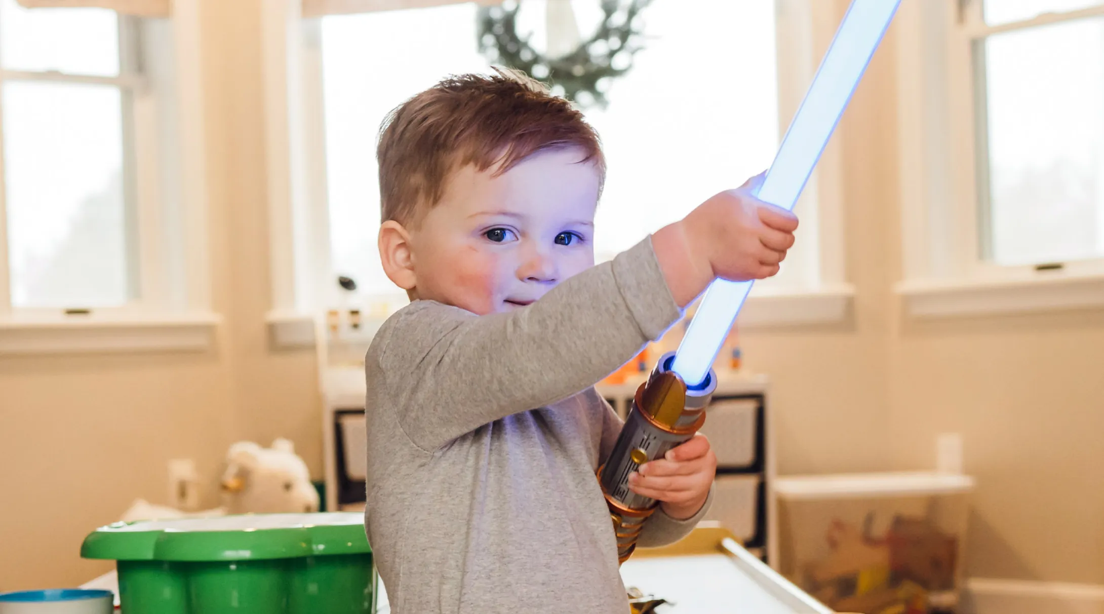 young boy holding light saber