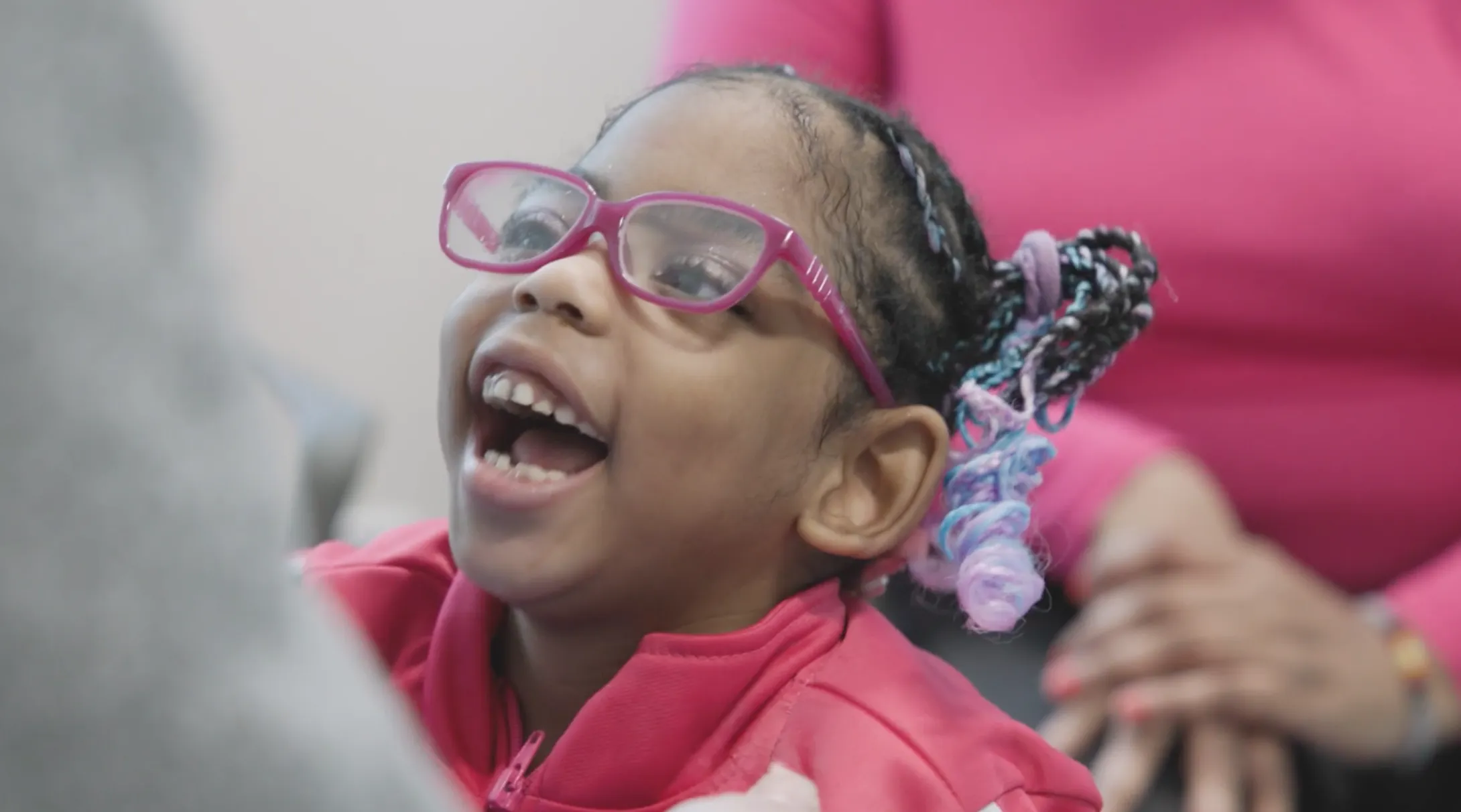 Girl with pink glasses and pink jacket
