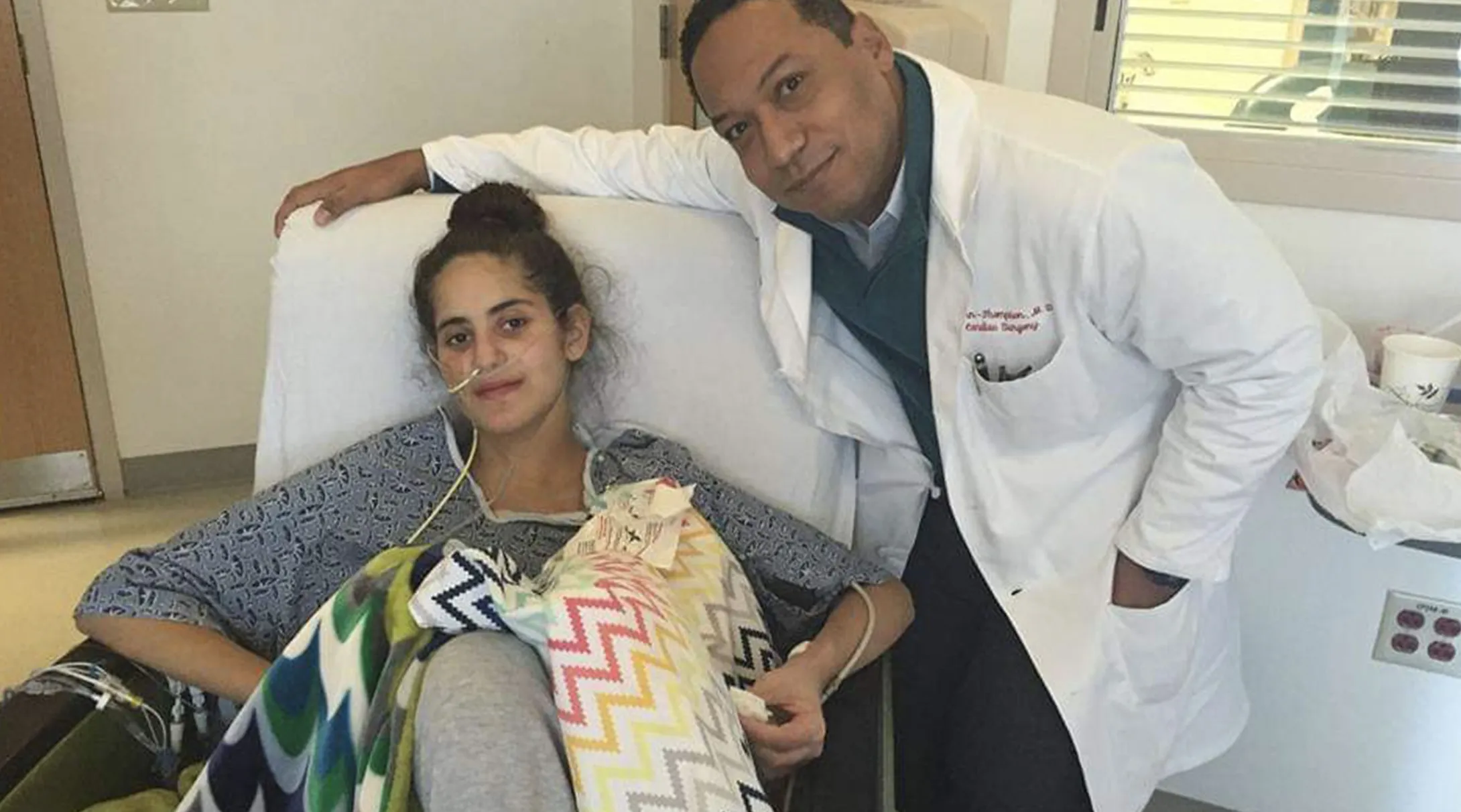 Nicole on hospital bed, doctor standing next to her