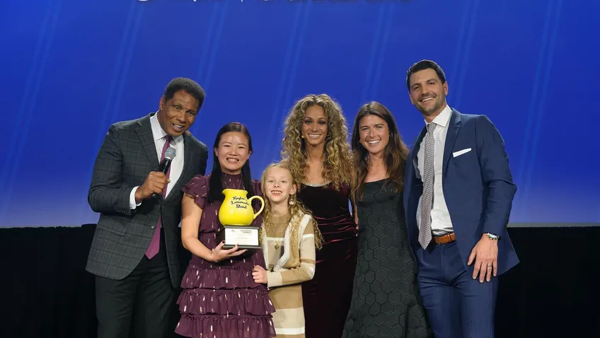 group of people standing on Champions for Children's stage
