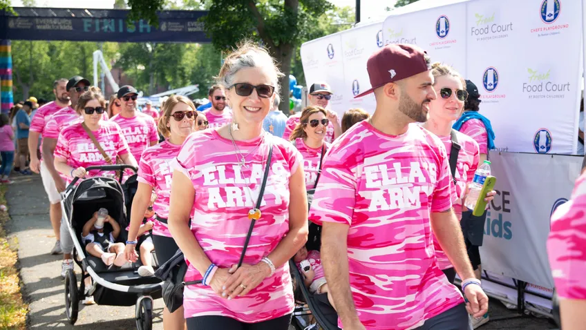 participants in pink tshirts walking for fundraising event