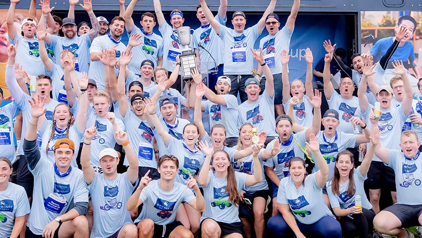 group of people raising their hands and cheering