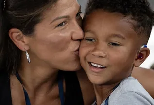 A mother kisses her son, Jeremiah