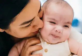 A mother kisses her baby son, Joshua