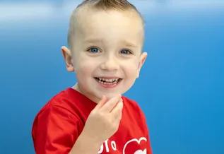 Jack smiling with his hand by his mouth