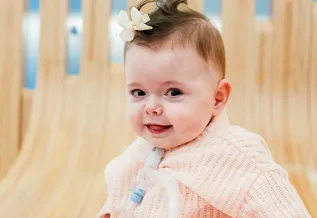 baby girl with bow tied in her hair