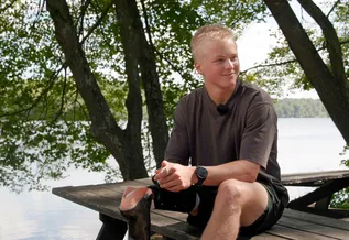 Jack sitting on a wooden table outdoors