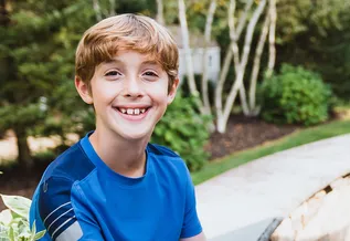 ryan sitting on a bench at a park