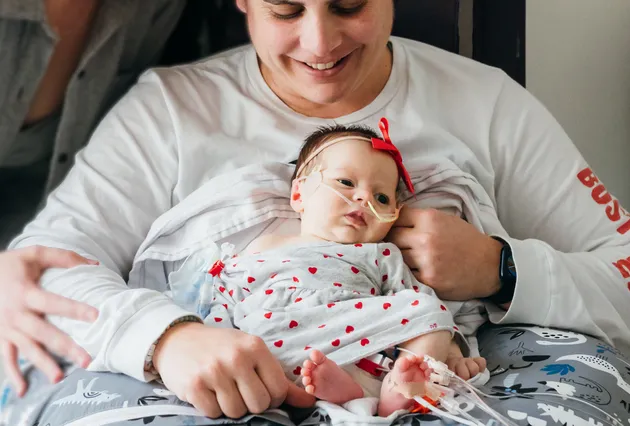 Kalea being held on a family member's lap